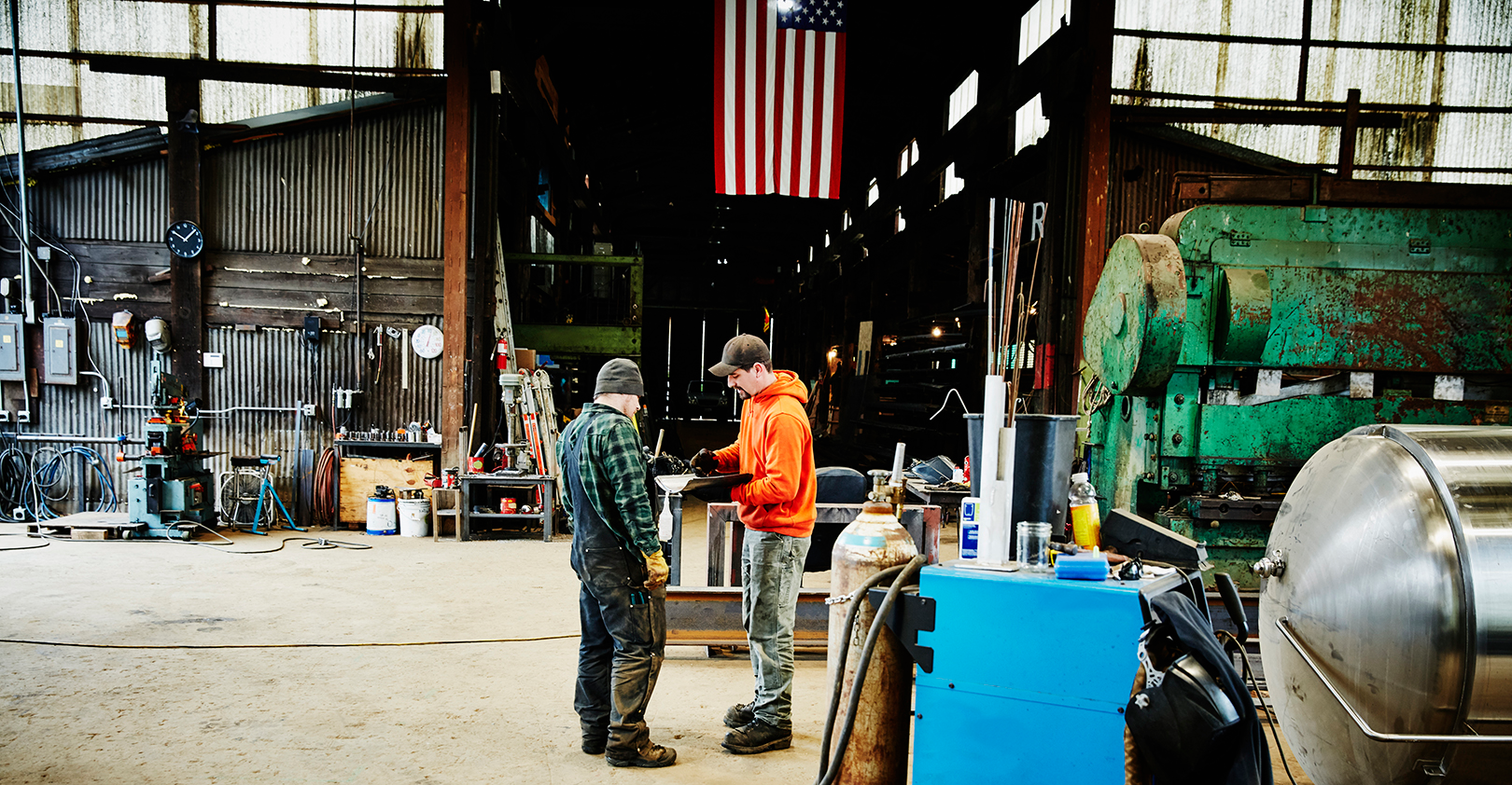 Metal Workers In Workshop Discussing Istock Getty 5e3d8cdeb9704