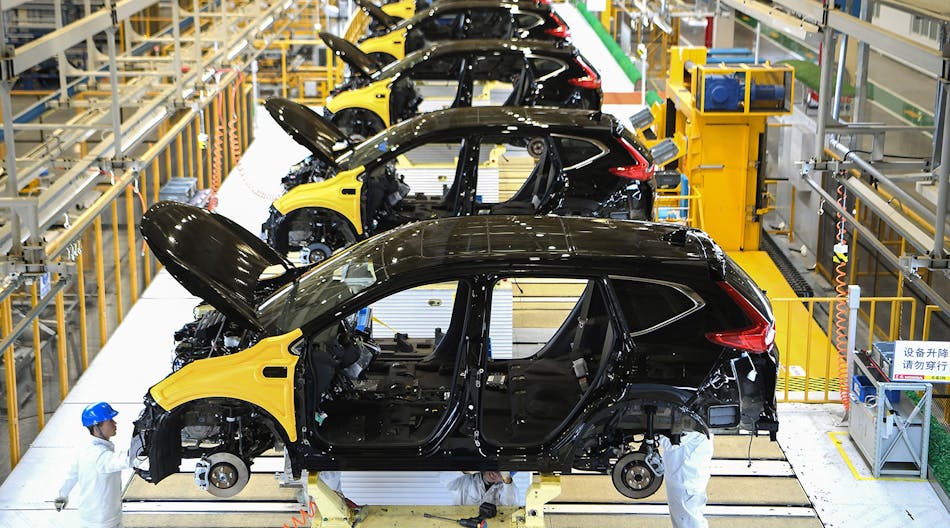 This photo taken on November 27, 2019 shows employees working on an assembly line at the third auto plant of Dongfeng Honda in Wuhan in China&apos;s central Hubei province.