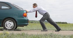 man pushing car man pushing car