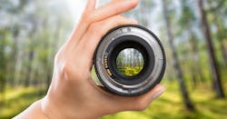 photographer holding lens photographer holding lens