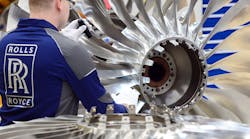 Rolls Royce Worker Examines Engine Blades