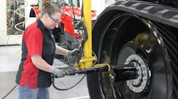 AGCO manufacturing employee working on equipment. AGCO manufacturing employee working on equipment.