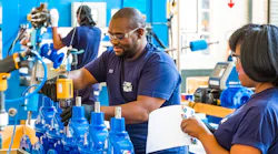 Black Engineers Factory Floor Valves Bright Blue Valves Manufacturing © Michael Turner Dreamstime