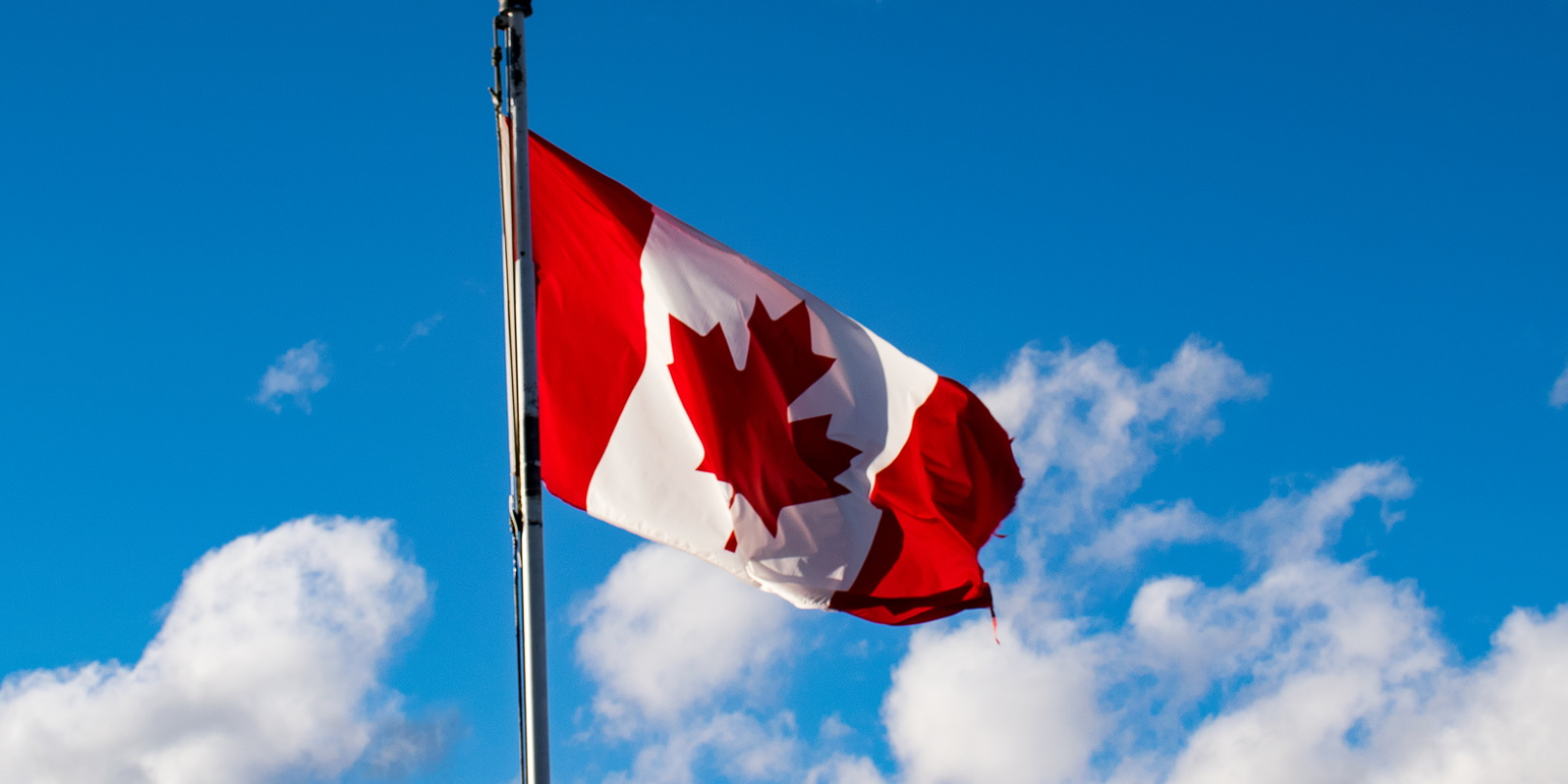 Canadian Flag In Front Of Blue Sky With Some White Clouds Nestor Arturo Velasco Diaz Dreamstime 5f89295f8fc96