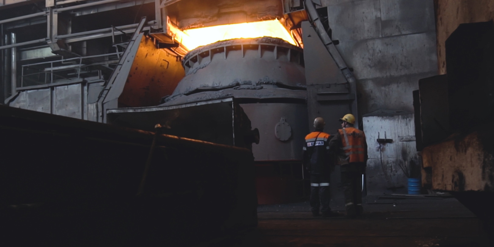 Employees In Front Of Metal Crucible Glowing Dark Factory Floor Media Whalestock Dreamstime 5f77845ca8c72