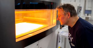 Dave Jacek, additive manufacturing technician, oversees production of 3D-printed disposable respirator mask prototypes at Ford&rsquo;s Advanced Manufacturing Center.