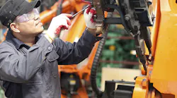 Manufacturing Guy Working On Machine T