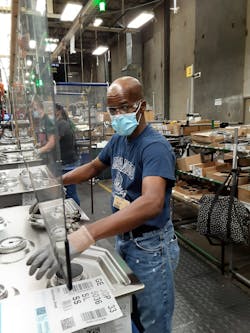 Team Leader Billie-Joe White installs shelves on a 19-cubic-foot top freezer refrigerator. Team Leader Billie-Joe White installs shelves on a 19-cubic-foot top freezer refrigerator.