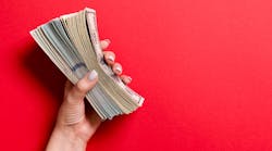 Hand Holding Money Bills Cash On Red Background &copy; Mykola Sosiukin Dreamstime