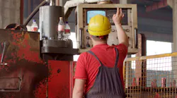 Employee In Helmet Operating Metal Process Machinery © Serhii Shchehlov Dreamstime