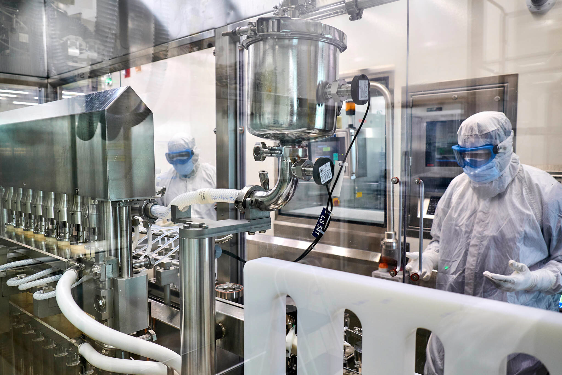 Filling technicians monitor vials being filled inside the aseptic core of a production line at the Greenville, North Carolina, Thermo Fisher Scientific facility. Real time monitoring is necessary to assure product quality and operational efficiency.