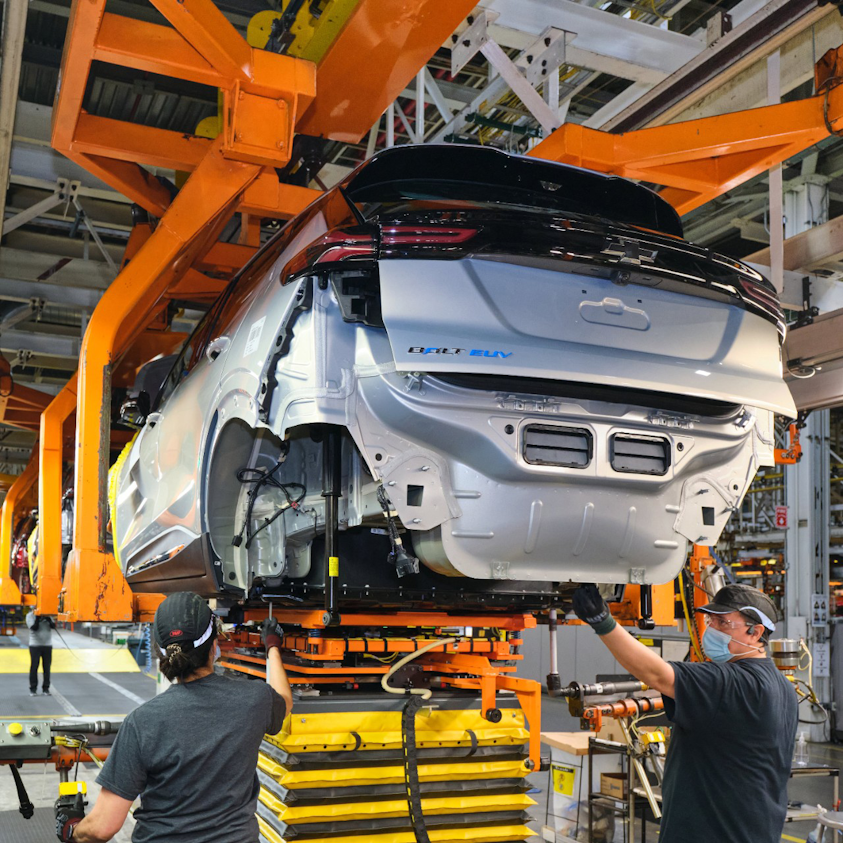 GM shut down most of its assembly plants temporarily in September because of the chip shortage. Here, workers assemble a 2022 Chevy Bolt at GM's Lake Orion plant in Michigan, one of the plants affected.