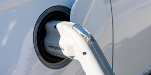 A close-up of an electric car charging port
