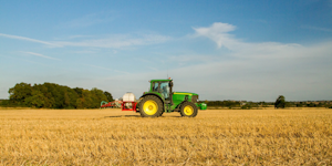 Green John Deere Tractor In Field Of Stubble Crops Spraying Field Agricultural Equipment © Bluetoes67 Dreamstime