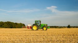 Green John Deere Tractor In Field Of Stubble Crops Spraying Field Agricultural Equipment &copy; Bluetoes67 Dreamstime