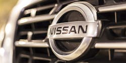 A closeup of the company's logo on the grille of a Nissan vehicle. A closeup of the company's logo on the grille of a Nissan vehicle.