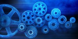A system of gears against a blue background. An abstract representation of manufacturing and industry. A system of gears against a blue background. An abstract representation of manufacturing and industry.