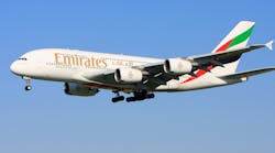 An Airbus A380 in Emirates Airlines livery, approaching the runway for a landing.