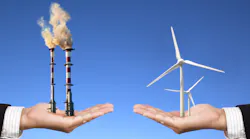 Hands Holding Smokestacks And Wind Turbines
