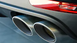 A closeup of a car's dual exhaust pipes.