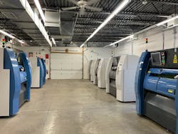 Rows of additive manufacturing machines waiting their next build orders, at Metalcraft Solutions.