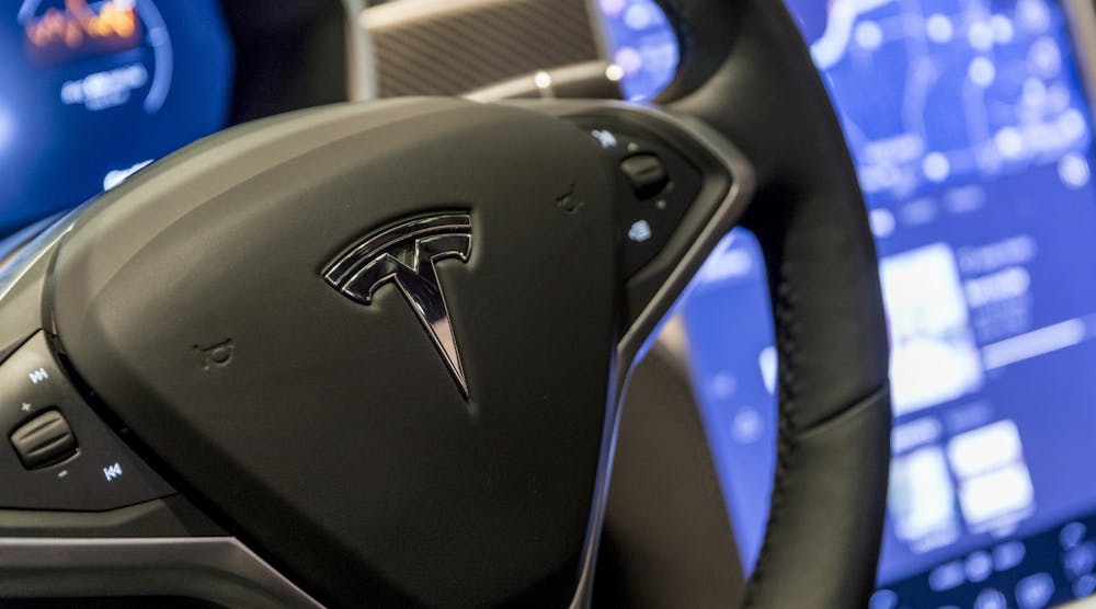 A closeup of the steering wheel of a Tesla Motors vehicle.