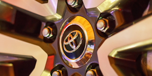 A Toyota logo seen on the hubcap of a car in closeup.