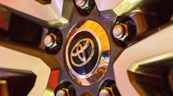 A Toyota logo seen on the hubcap of a car in closeup.