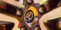 A Toyota logo seen on the hubcap of a car in closeup. A Toyota logo seen on the hubcap of a car in closeup.