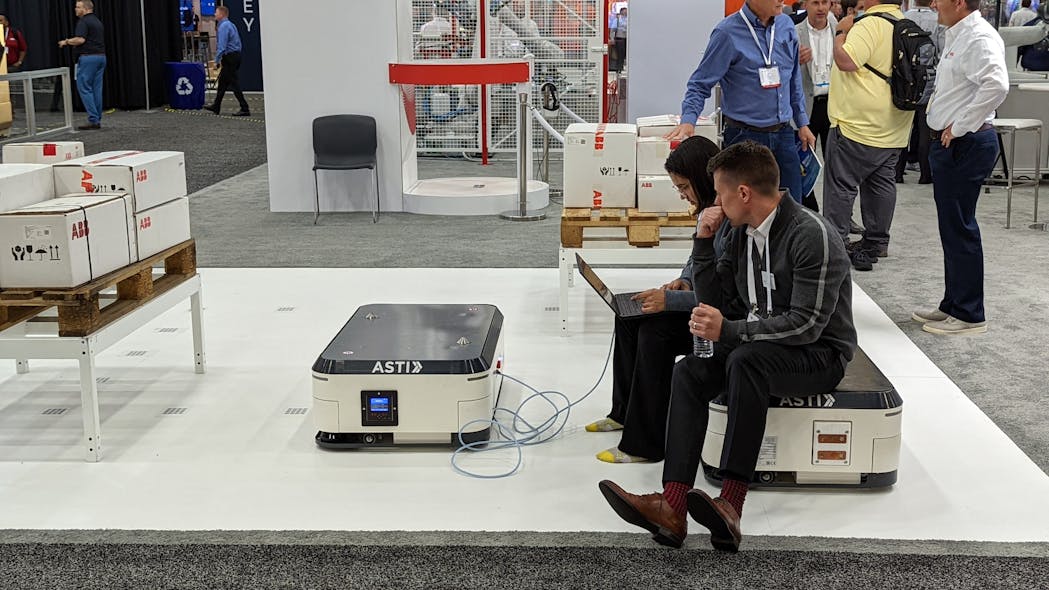 Employees use an ABB autonomous mobile robot (AMR) as a seat at the company&apos;s Automate booth.