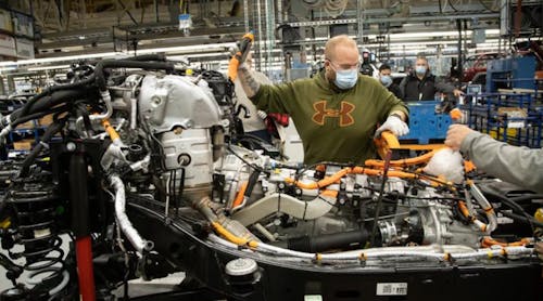 An autoworker at Stellantis&apos; Toledo, Ohio, Jeep plant works on an electric version of the Wrangler. The UAW and automakers will no longer require workers to wear facemasks to protect against COVID-19.
