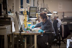 A production worker prepares an aluminum mold before it's used to produce an initial run of parts for customer verification. A production worker prepares an aluminum mold before it's used to produce an initial run of parts for customer verification.