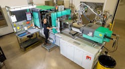 Briana Miranda operates an injection molding machine on the factory floor. Briana Miranda operates an injection molding machine on the factory floor.
