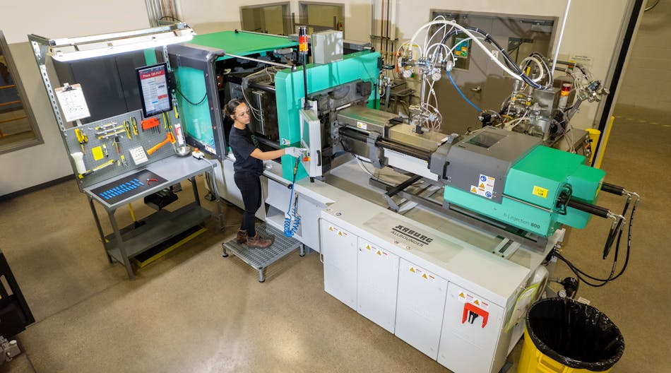 Briana Miranda operates an injection molding machine on the factory floor.