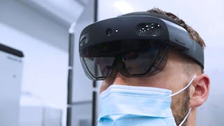 An Ericsson employee at the Lewisville plant wearing a pair of Microsoft Hololens augmented reality (AR) glasses.
