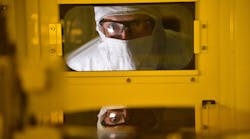 An Intel production worker in Hillsboro, Oregon, produces semiconductors in a cleanroom environment.