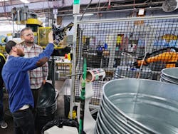 Bill Bellingham, vice president of manufacturing at Behrens (right) inspects cobot operations on the plant floor.