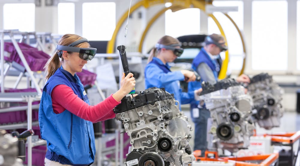 A BMW trainee uses augmented reality goggles to guide engine assembly.