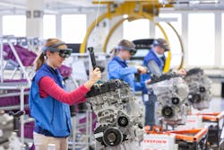 A BMW trainee uses augmented reality goggles to guide engine assembly. A BMW trainee uses augmented reality goggles to guide engine assembly.