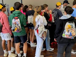 High school students from Dublin, Ohio, head to the plant tour after picking up their swag bags. High school students from Dublin, Ohio, head to the plant tour after picking up their swag bags.