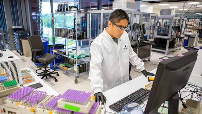 A researcher in Vertex Pharmaceuticals San Diego, California, lab works on test samples. Much of Vertex's cystic fibrosis research comes out of the California lab.