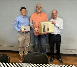 Josiah Haas, George Helsius and Blair Haas with a plaque and a custom-printed special enclosure that will be incorporated into a resonator guitar for George's 50- year anniversary with the company. Josiah Haas, George Helsius and Blair Haas with a plaque and a custom-printed special enclosure that will be incorporated into a resonator guitar for George's 50- year anniversary with the company.