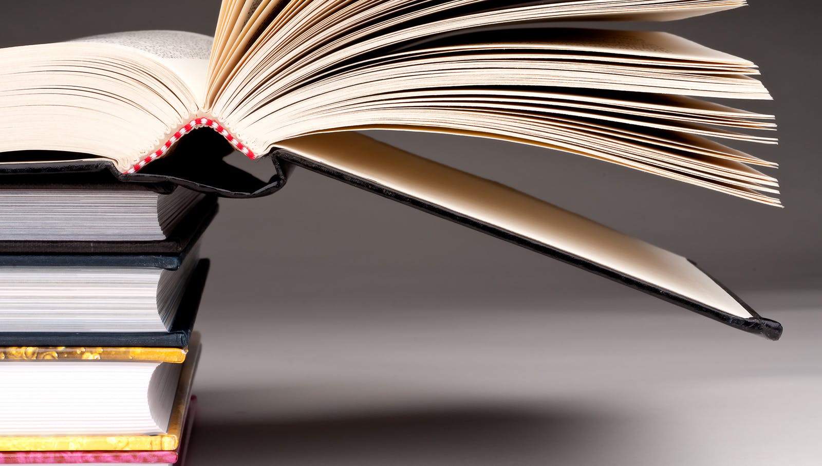 66a3bde8513c397a51bda251 Book Stack Dreamstime L 8551640