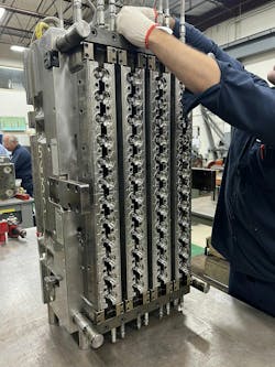 A toolmaker works on an injection molding tool at Hoffer Plastics. High-pressure screws will inject plastic into the cavities of the tool, creating the caps and lids that Hoffer makes. A toolmaker works on an injection molding tool at Hoffer Plastics. High-pressure screws will inject plastic into the cavities of the tool, creating the caps and lids that Hoffer makes.