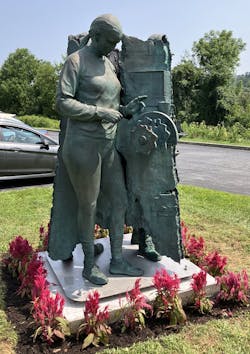 This is one angle of the statue that portrays two women and one man, each performing a different task emblematic of modern manufacturing and the diverse tasks that make it go. Company founder Bill Hindle commissioned the piece. This is one angle of the statue that portrays two women and one man, each performing a different task emblematic of modern manufacturing and the diverse tasks that make it go. Company founder Bill Hindle commissioned the piece.