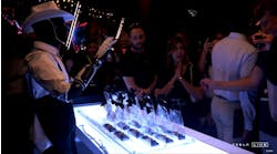 A Telsa Optimus robot hands out gift cards at a recent Hollywood event. Though CEO Elon Musk has called the humanoid robots autonomous, human handlers managed the robots via remote control during the event. A Telsa Optimus robot hands out gift cards at a recent Hollywood event. Though CEO Elon Musk has called the humanoid robots autonomous, human handlers managed the robots via remote control during the event.