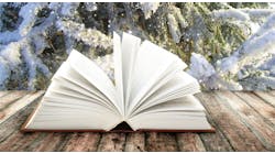 open book on table outdoors in winter setting open book on table outdoors in winter setting