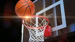 basketball entering hoop on dark background basketball entering hoop on dark background
