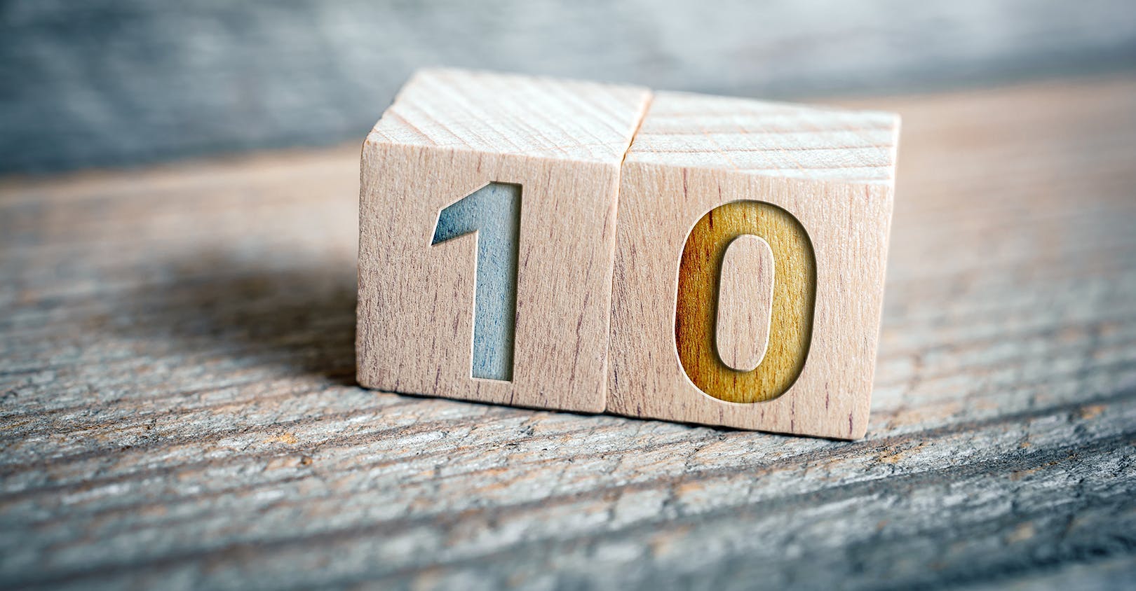 Two wooden blocks displaying the number ten.