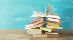Stack of books against light blue background.